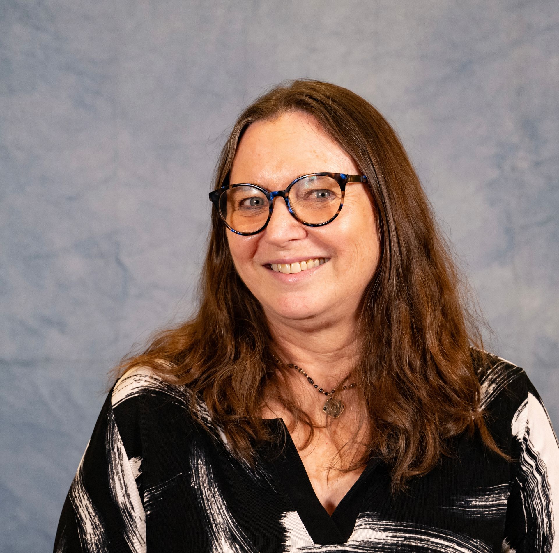 A image a lady with long hair, and galsses