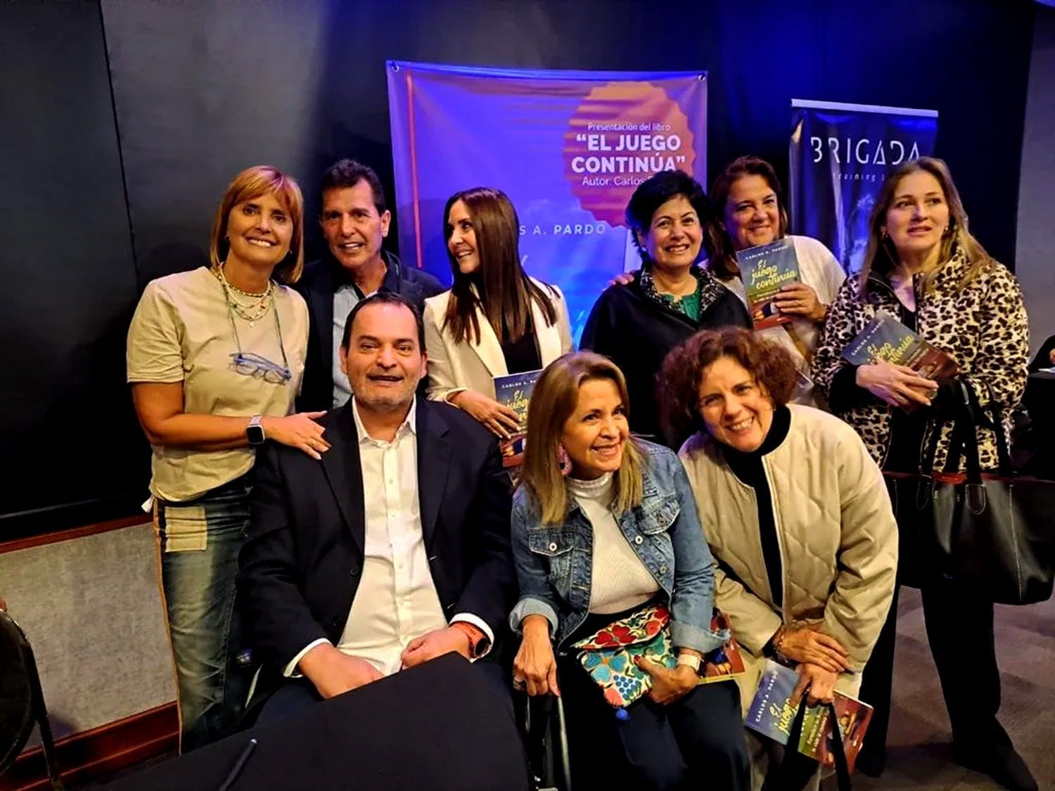 A group of people are posing for a picture in a room.