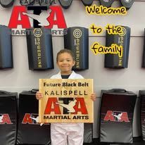A child holding a sign that reads