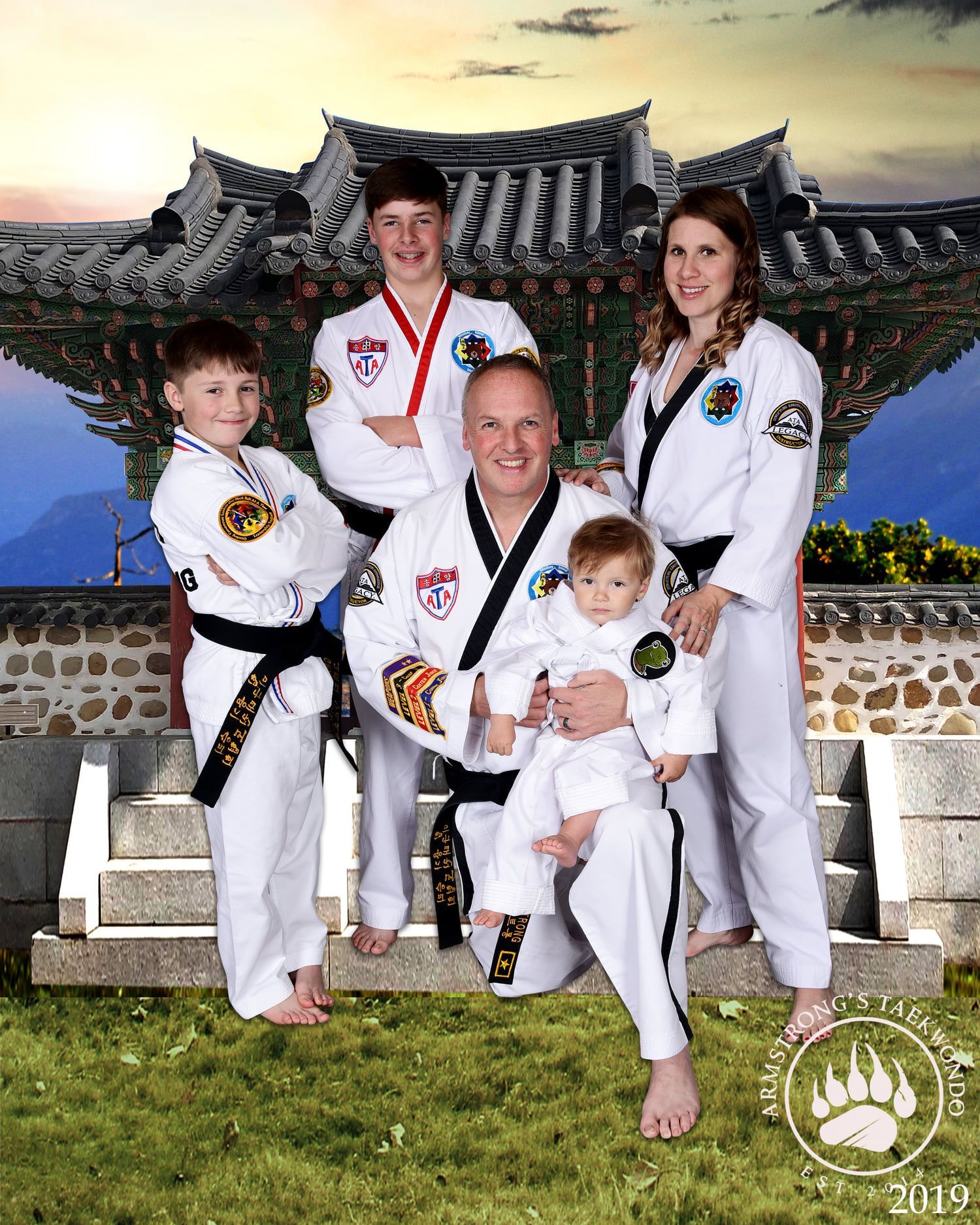 Family in Taekwondo uniforms, practicing martial arts. Text indicates a black belt achievement.
