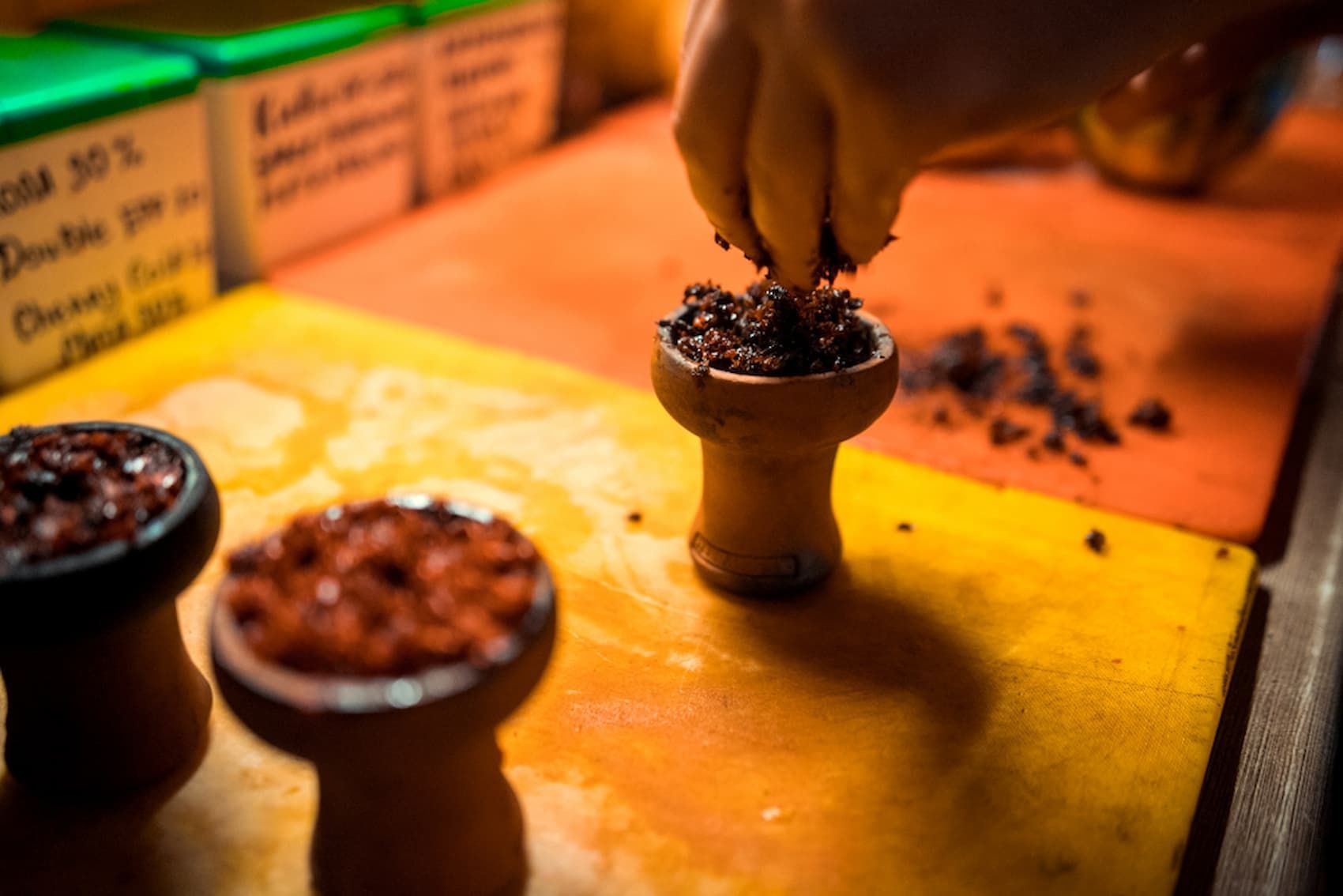 A Person Is Making a Hookah on A Table — Mini Market Townsville Smoke Shop