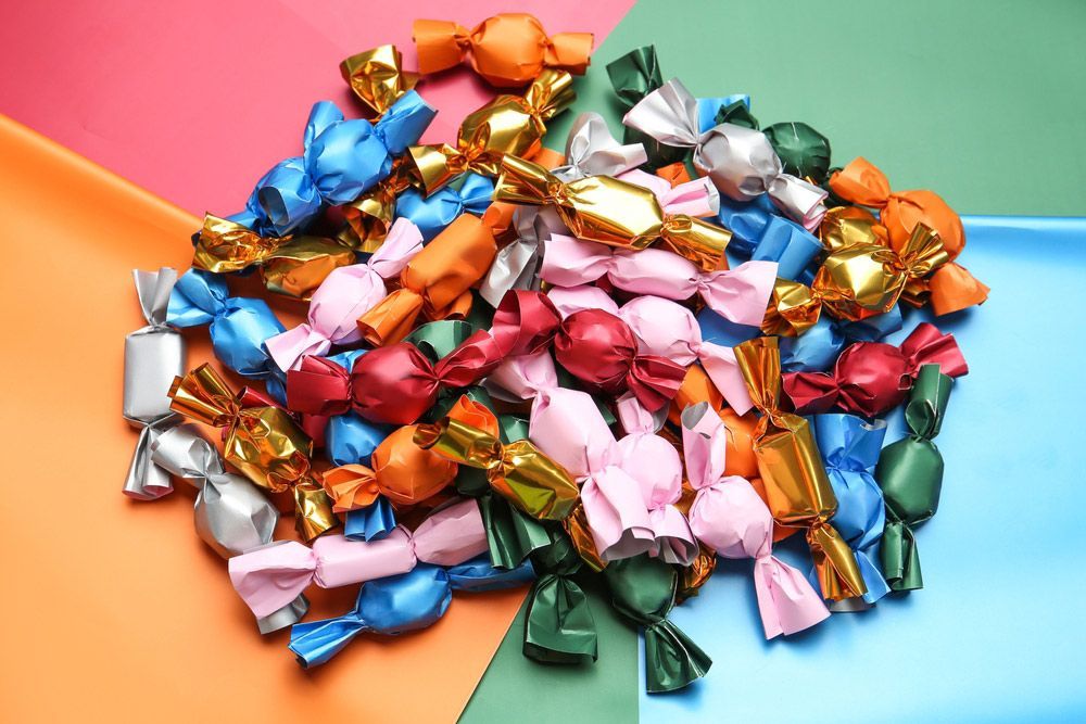 A Pile of Colourful Wrapped Candies on A Table — Mini Market Townsville Smoke Shop in Townsville City, QLD