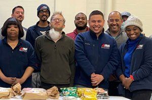 Employees at A&M Industrial volunteering for a community fundraiser, illustrating corporate social responsibility