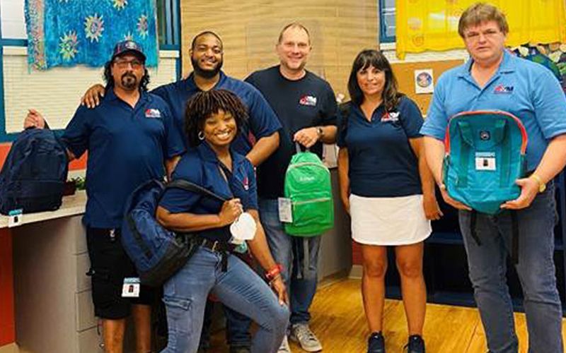 A&M Industrial Team at a United Way Stuff the Bus Event, supporting local schools.