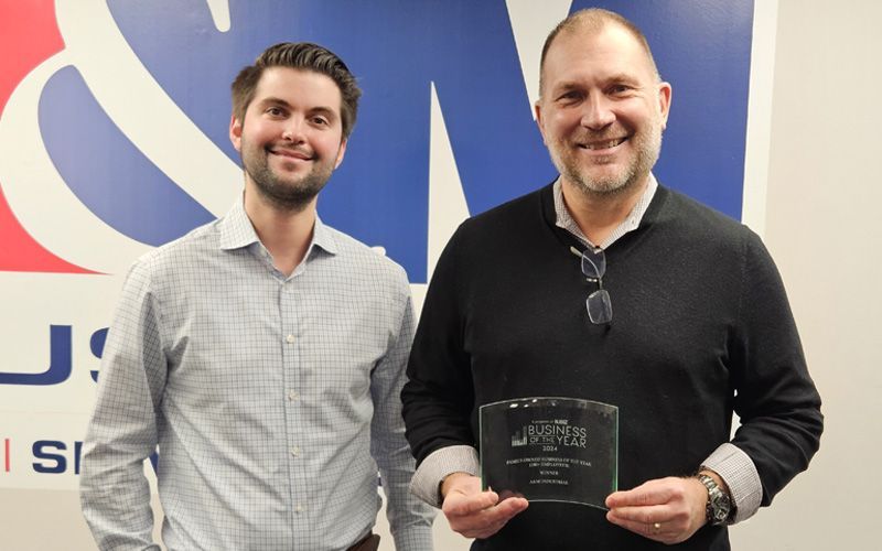 A&M's Josh Young and Rob Zatorsky pose with NJBIZ Business of the Year Award