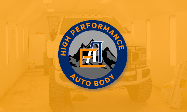 Overhead view of a dark gray roof, with a green and yellow logo featuring a stylized house and the letter