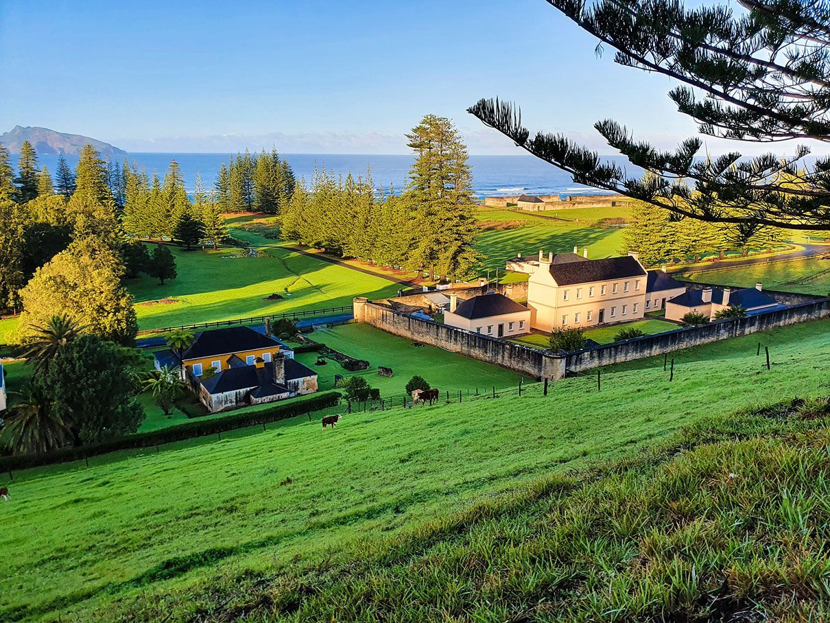 Green landscape with a historic house and ocean view. Norfolk Island Trade Winds Seniors Sanctuary