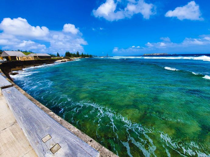 A view of the ocean from a pier on a sunny day