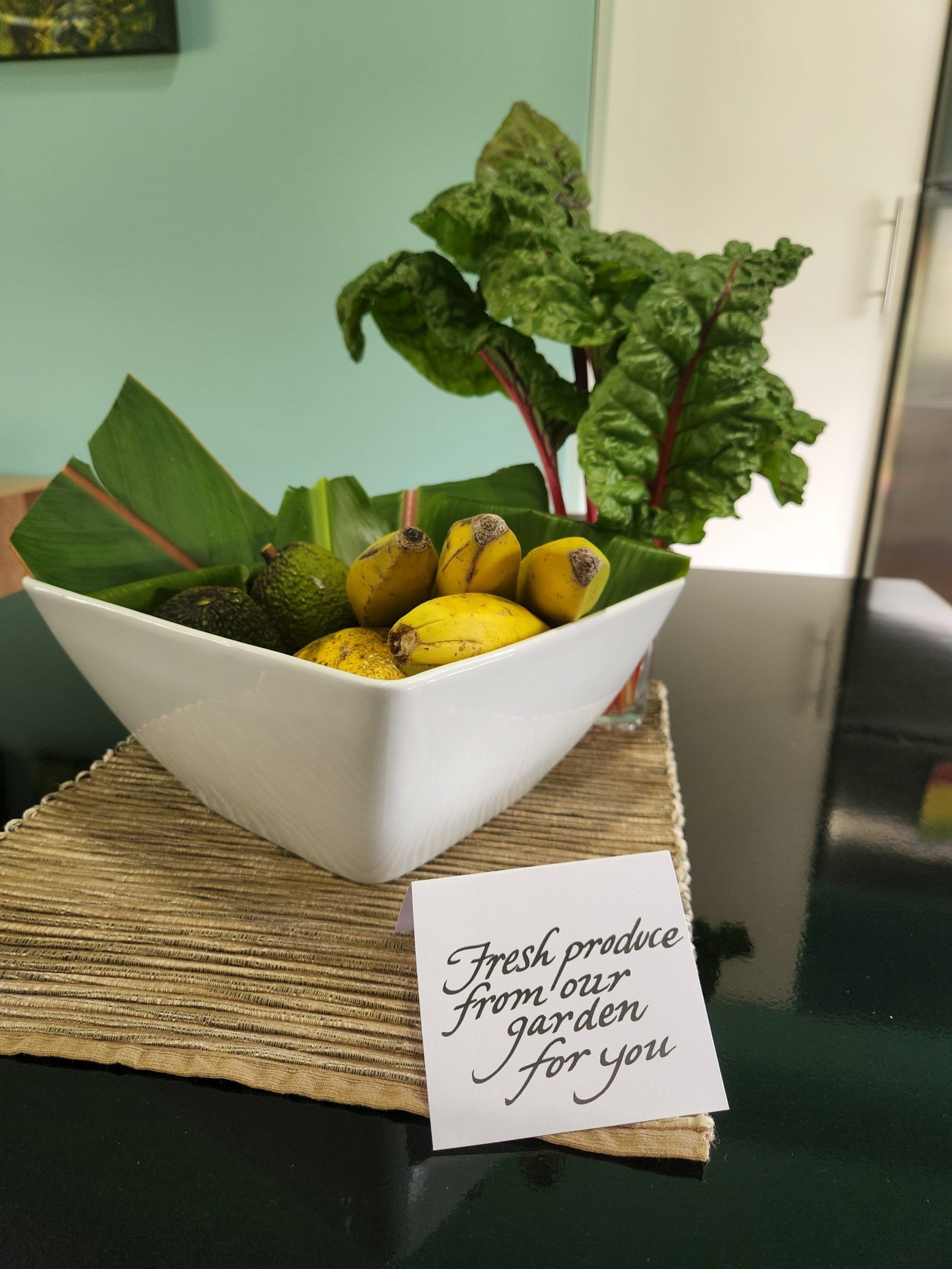White bowl with avocados, bananas, greens, and a handwritten note. Norfolk Island Trade Winds Seniors Sanctuary