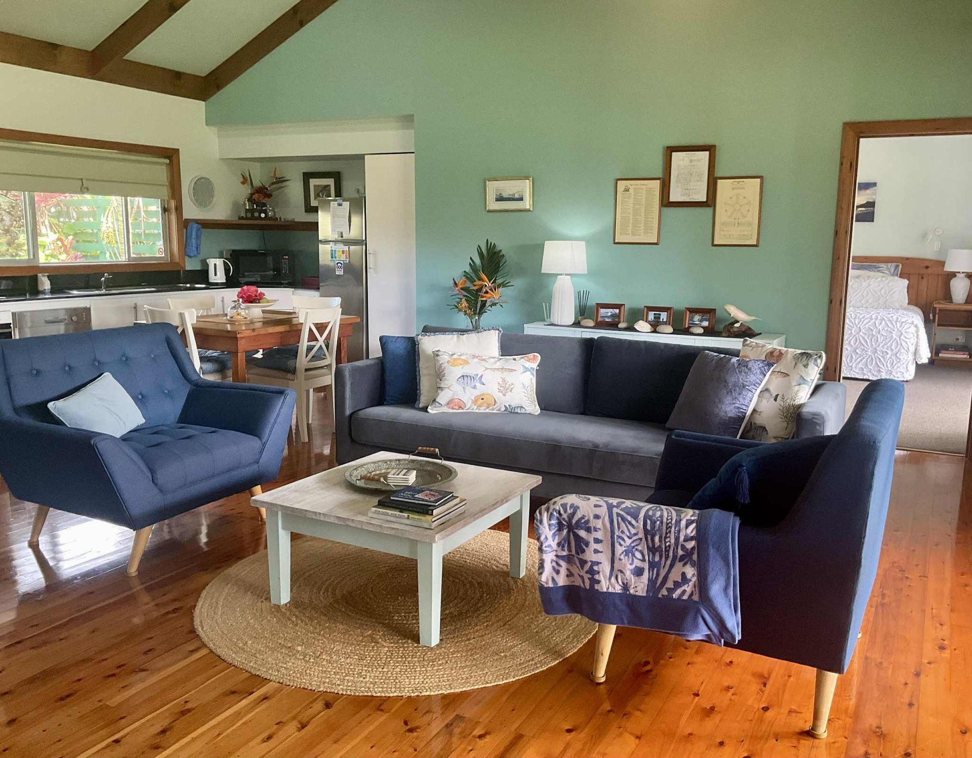 Living room with blue furniture, mint green wall. Norfolk Island Trade Winds Seniors Sanctuary