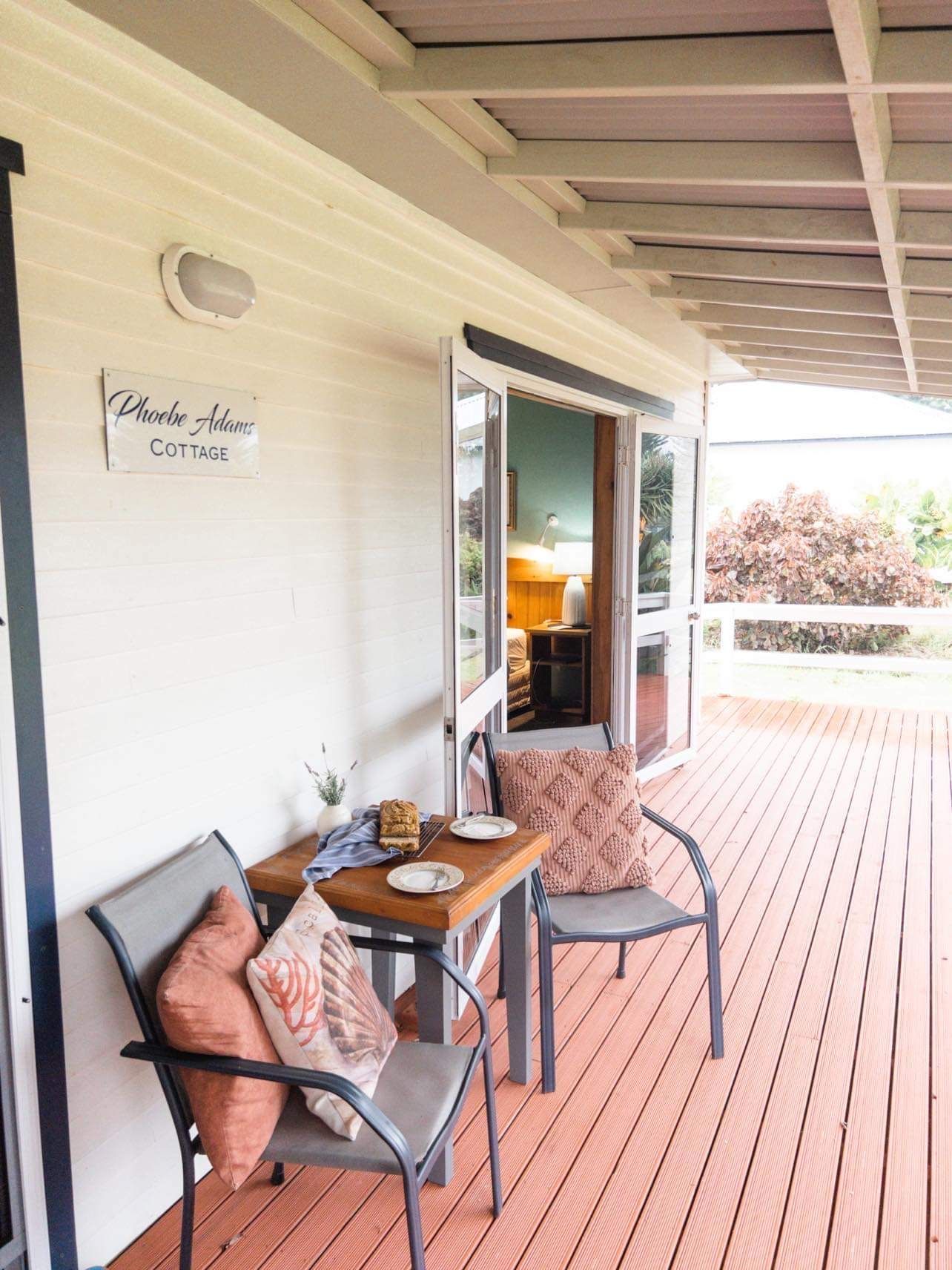 A porch with table and chairs, inviting entry to a home. Norfolk Island Trade Winds Seniors Sanctuary