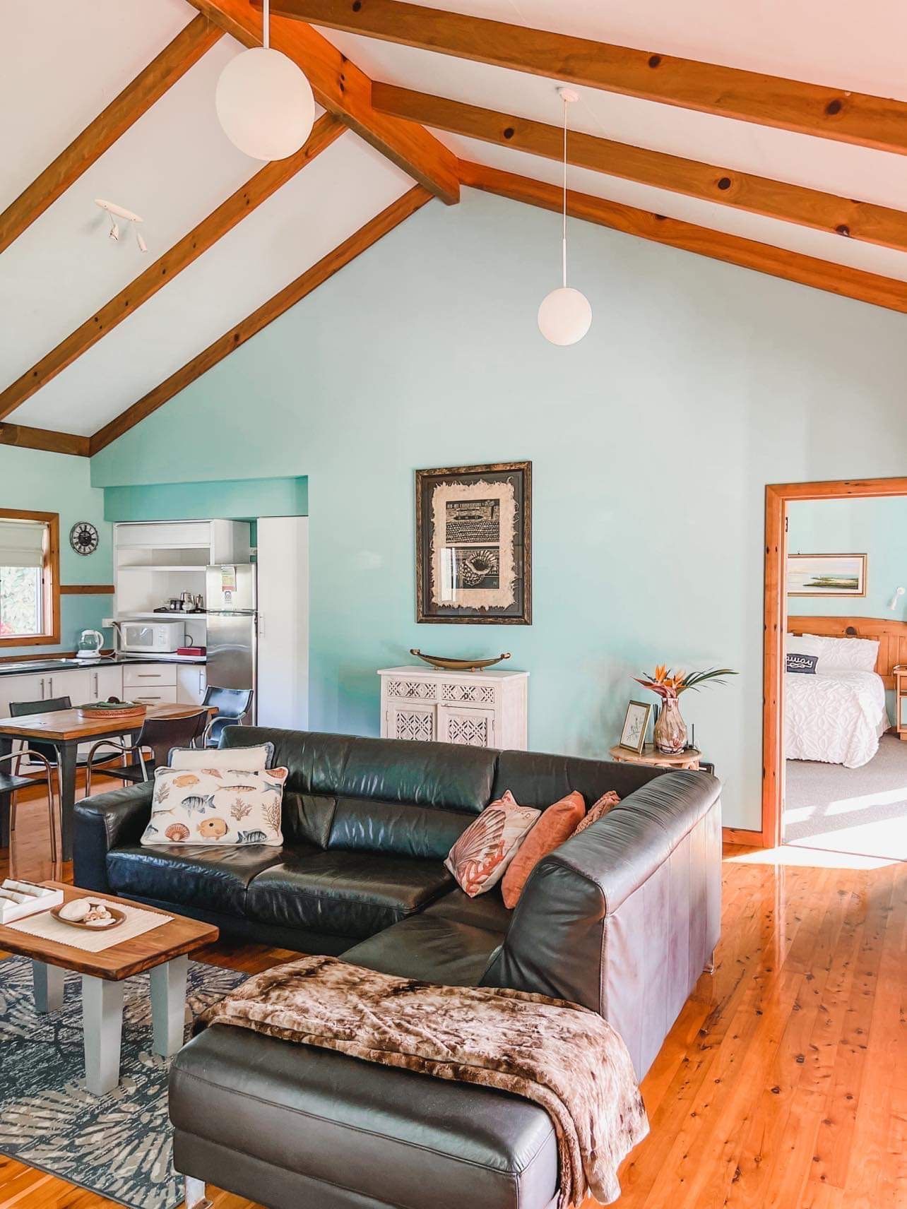 Living room with black leather sofa. Norfolk Island Trade Winds Seniors Sanctuary
