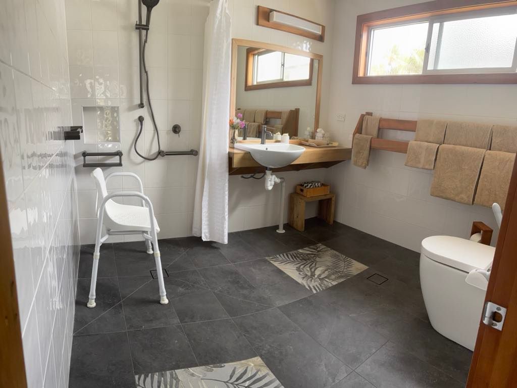 Accessible bathroom with shower, featuring grab bars and a low-threshold shower. Norfolk Island Trade Winds Seniors Sanctuary