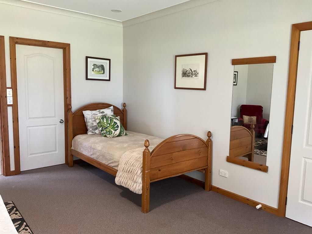 Bedroom with single bed, art, and a mirror.Norfolk Island Trade Winds Seniors Sanctuary Flinders