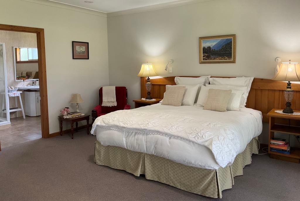 Bedroom with bed, nightstands and doorway to a bathroom. Norfolk Island Trade Winds Seniors Sanctuary Flinders