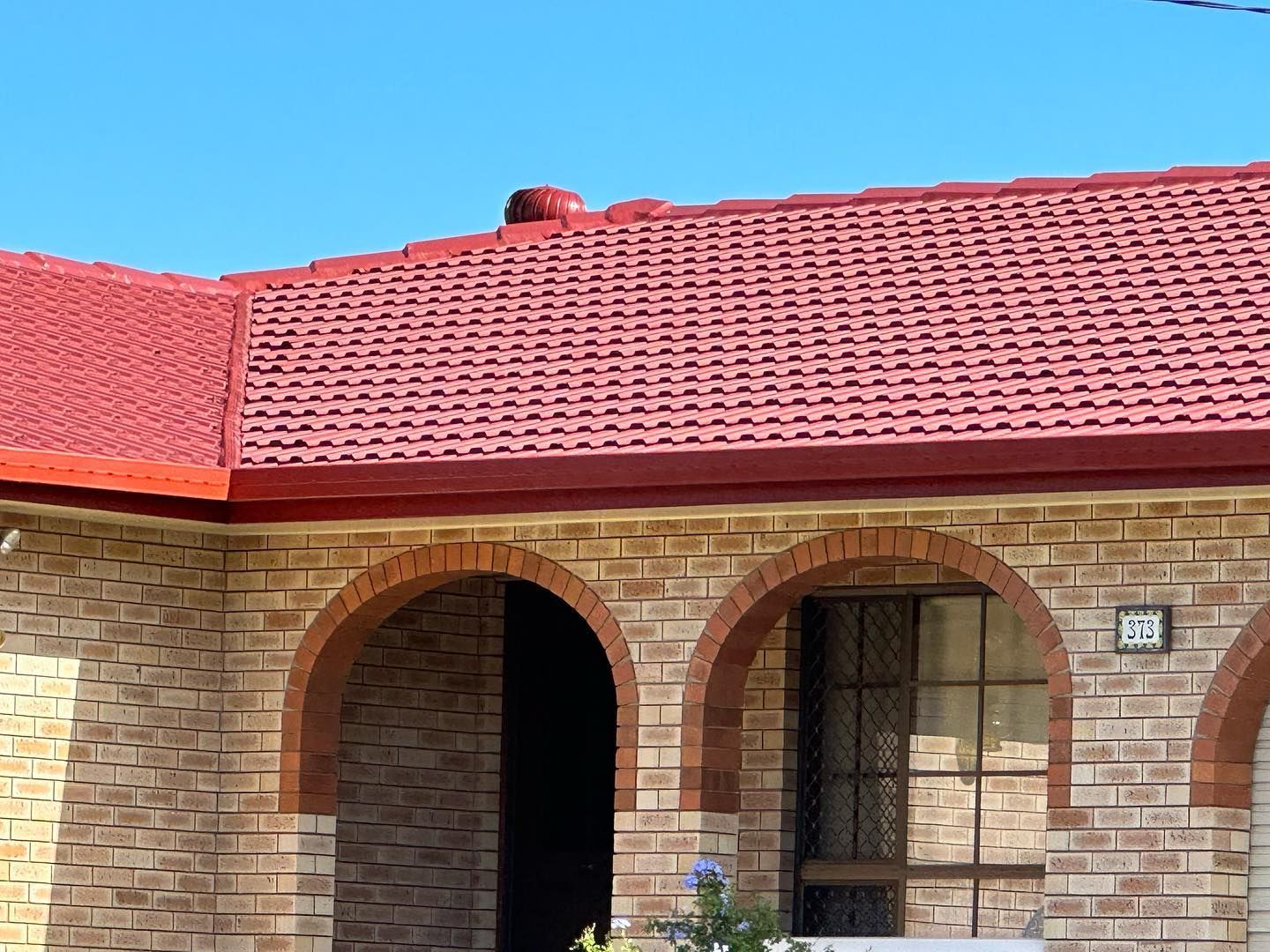 Brick Home With Red Tile Roof and Arched Doorways, Blue Sky — Roof Tek CQ in Rockhampton, QLD