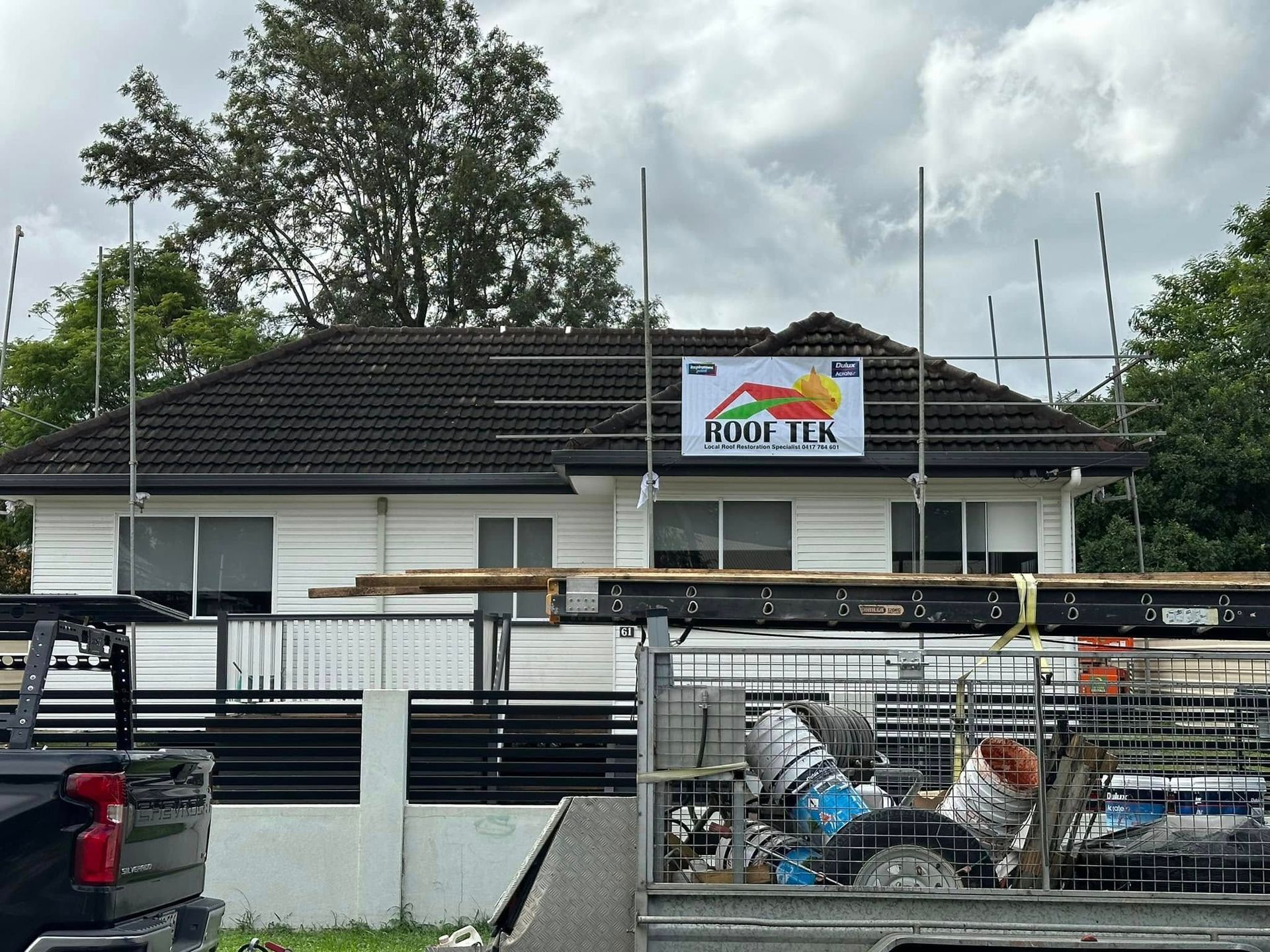 Workers on a Tiled Roof in a Residential Area — Roof Tek CQ in Rockhampton, QLD