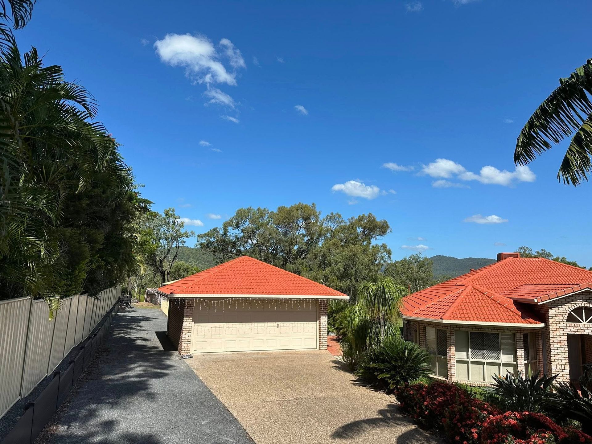 Brown Corrugated Metal Roof With a Chimney Under a Cloudy Sky — Roof Tek CQ in Rockhampton, QLD