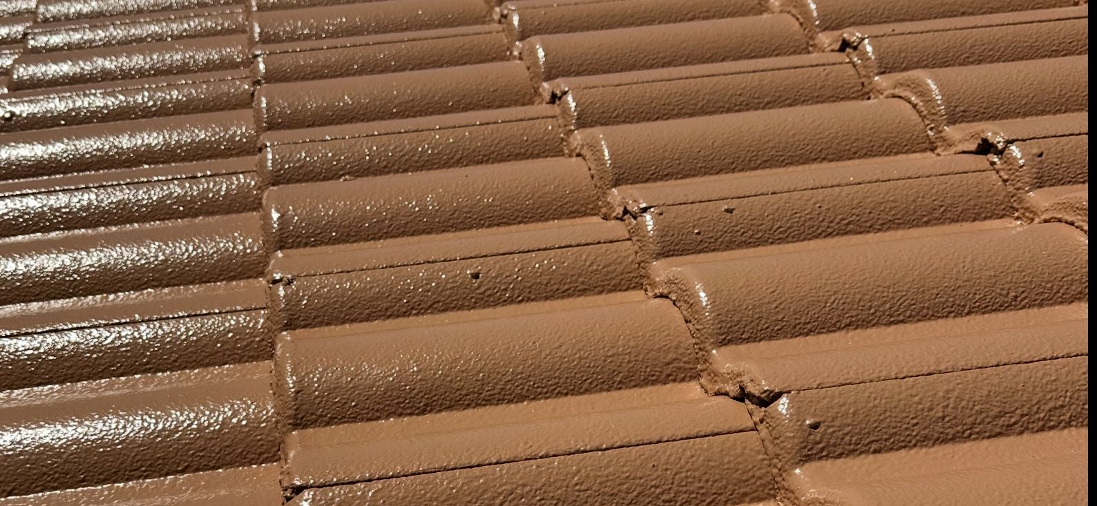 Close-up of brown roof tiles with a textured surface, possibly ceramic — Roof Tek CQ in Gracemere, QLD