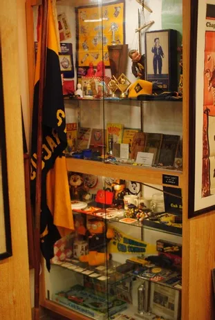 A tall display case full of a large number of scouting memorabilia