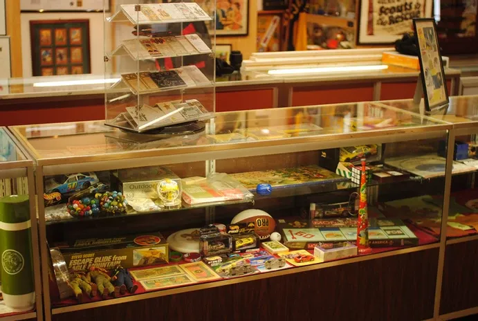 A glass display case of scouting graphics and collectibles