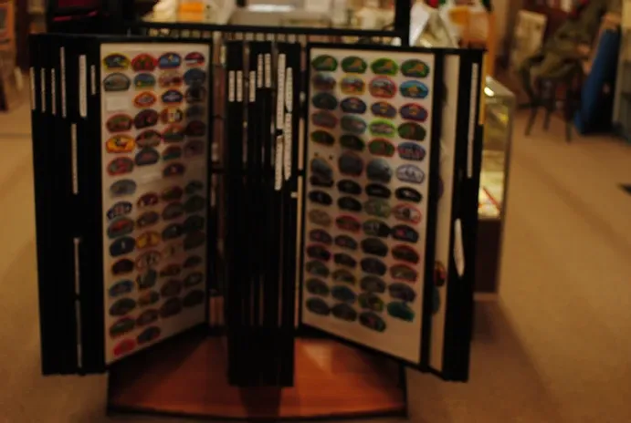 A large rotating display board full of scouting badges
