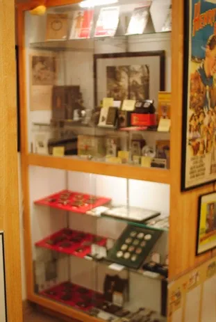 A tall glass display case of scouting medals