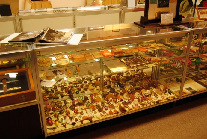 A glass display case full of scouting collectibles