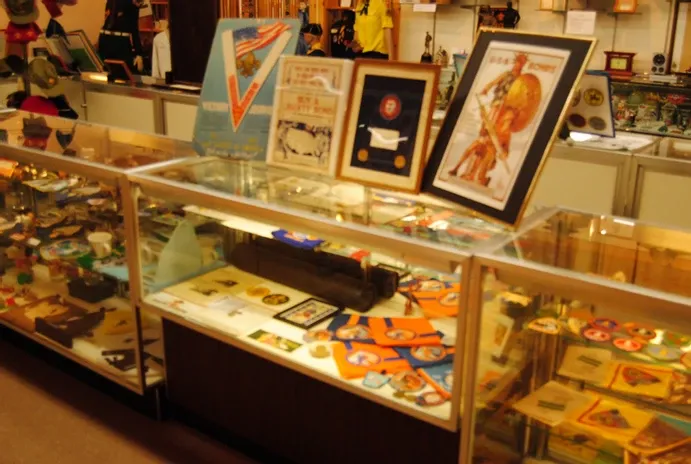 A display case of a large number of scouting posters and awards