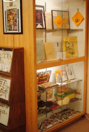 A tall display case of scouting posters