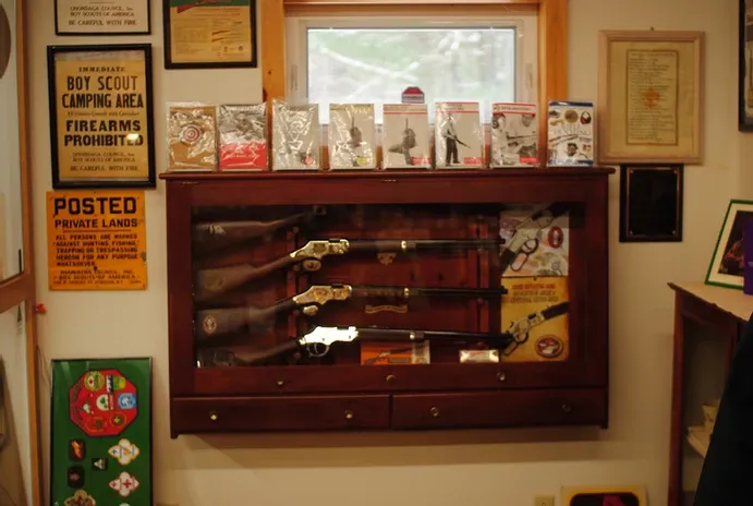 A display case of scouting rifles