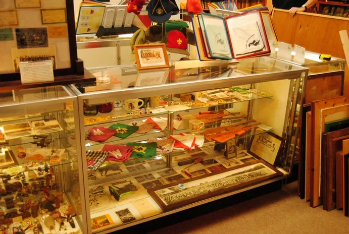 A glass display case of scouting flags