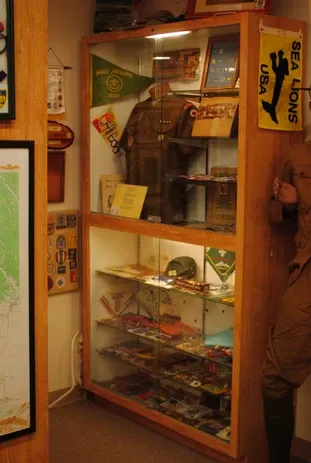 A display case of clothing and other scouting memorabilia