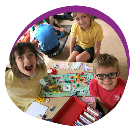 A group of children are sitting around a table playing a board game