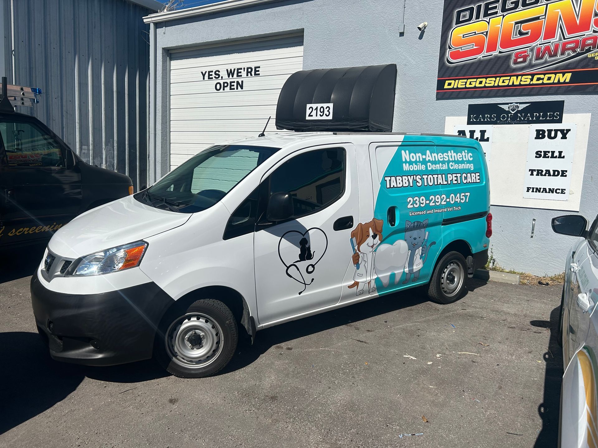 Vet tech performing gentle pet dental care for a healthy dog smile. Doggy Dental Naples, FL