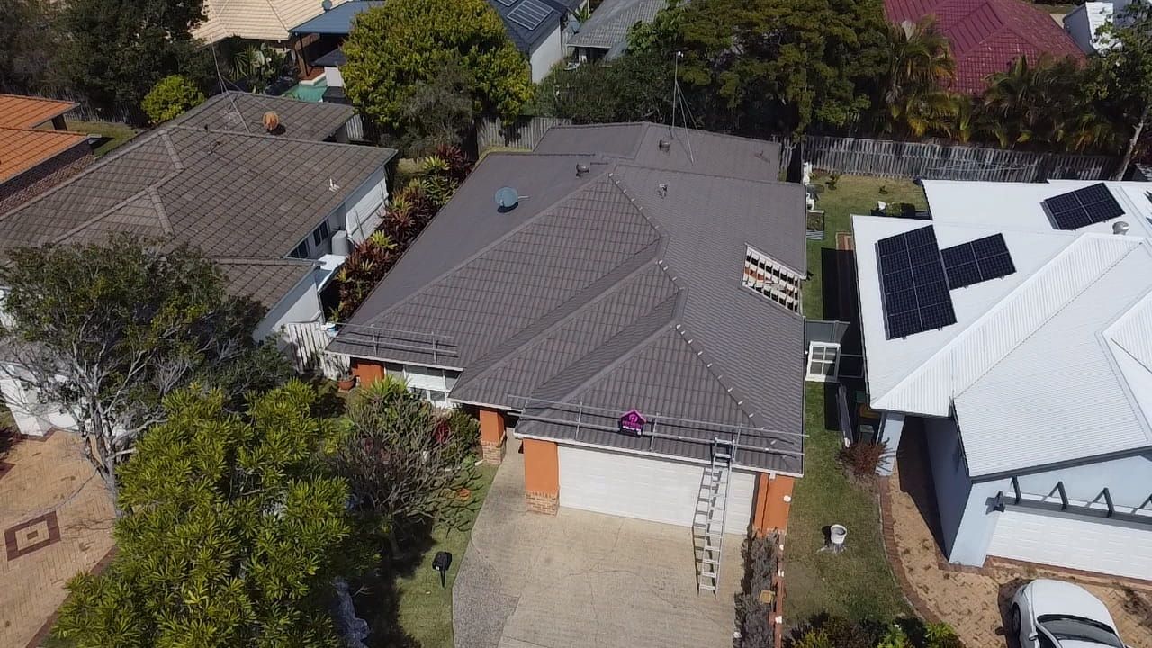 An aerial view of a Gold Coast roof being repaired.