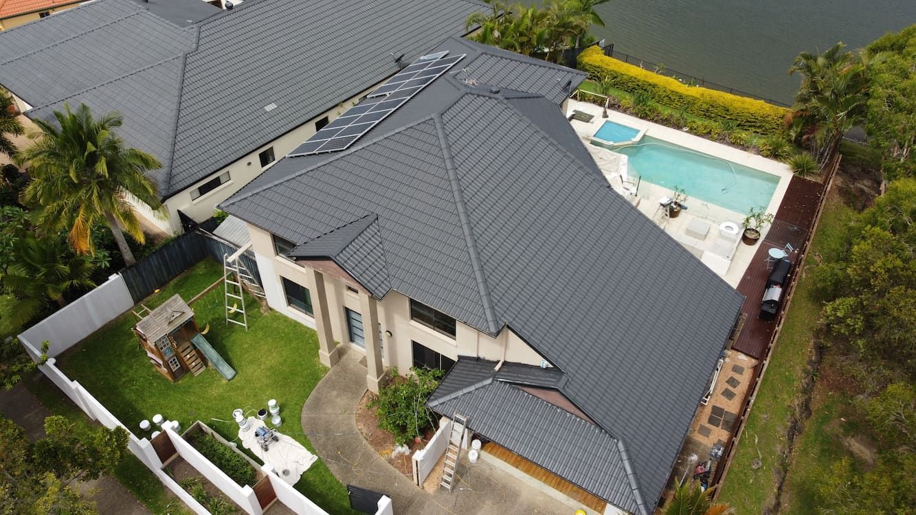 An aerial view of a large Gold Coast house with a pool in the backyard.