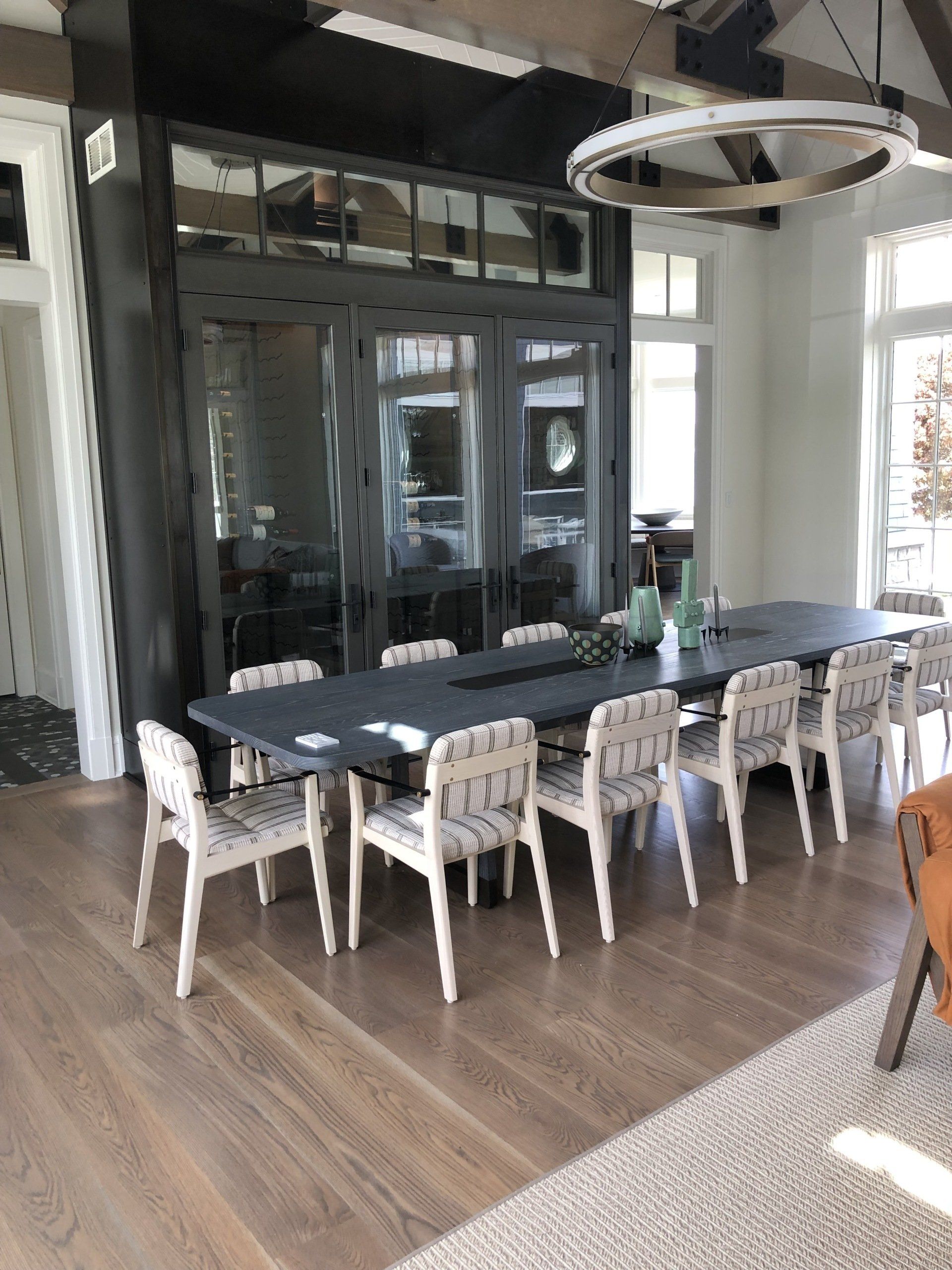 A large dining room with a long table and chairs.
