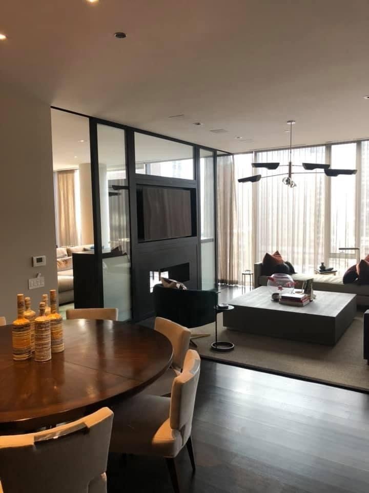 A living room with a table and chairs and a fireplace