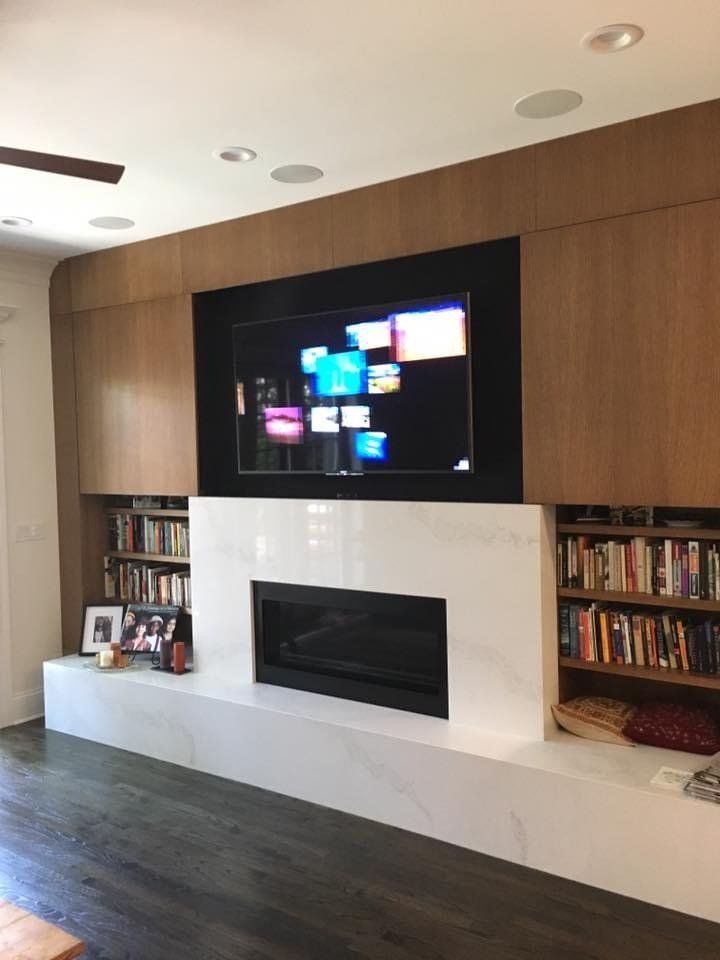 A living room with a fireplace and a flat screen tv
