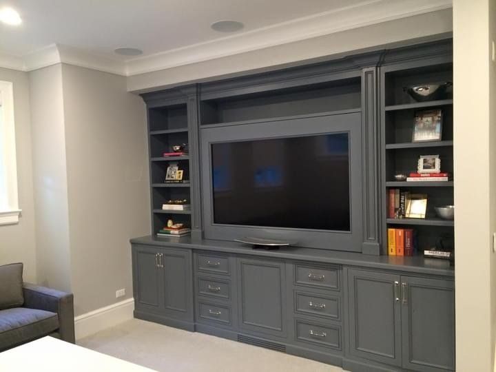 A living room with a large flat screen tv on the wall.