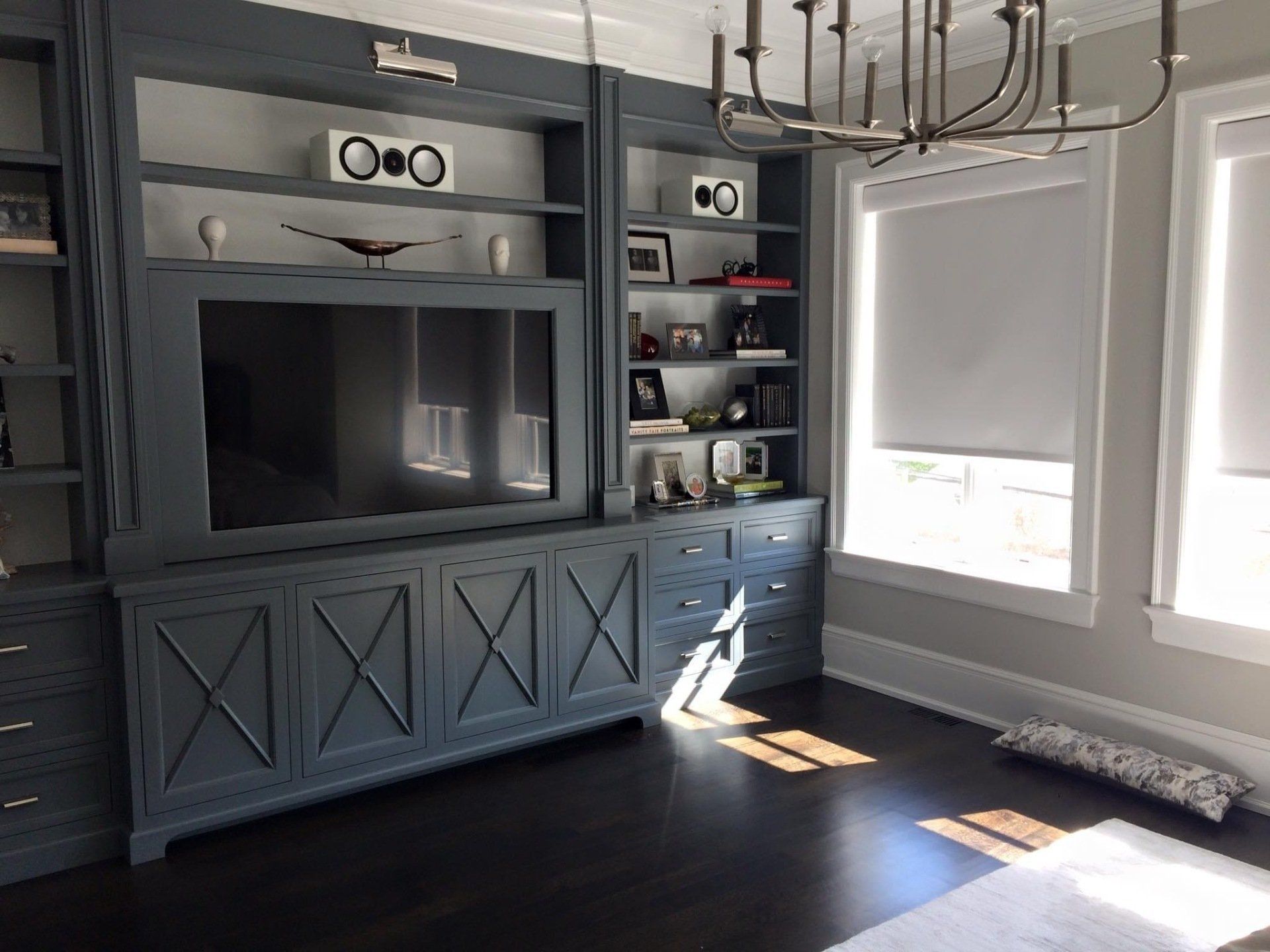 A living room with a large flat screen tv on the wall.