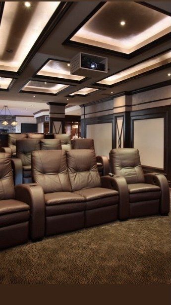 A room with a lot of chairs and a projector on the ceiling