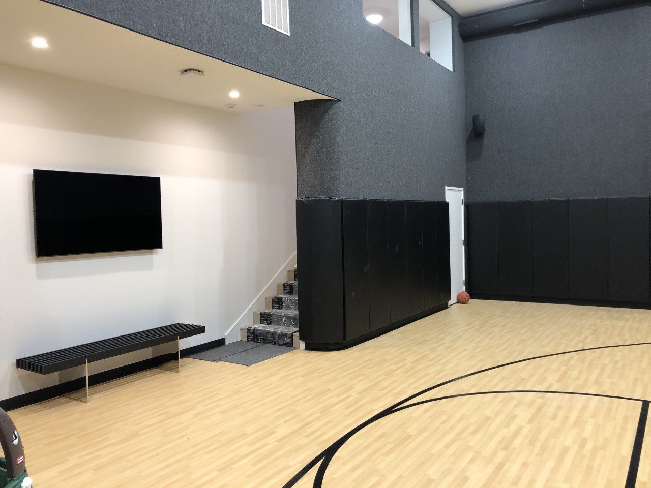 There is a basketball court in the middle of the room.