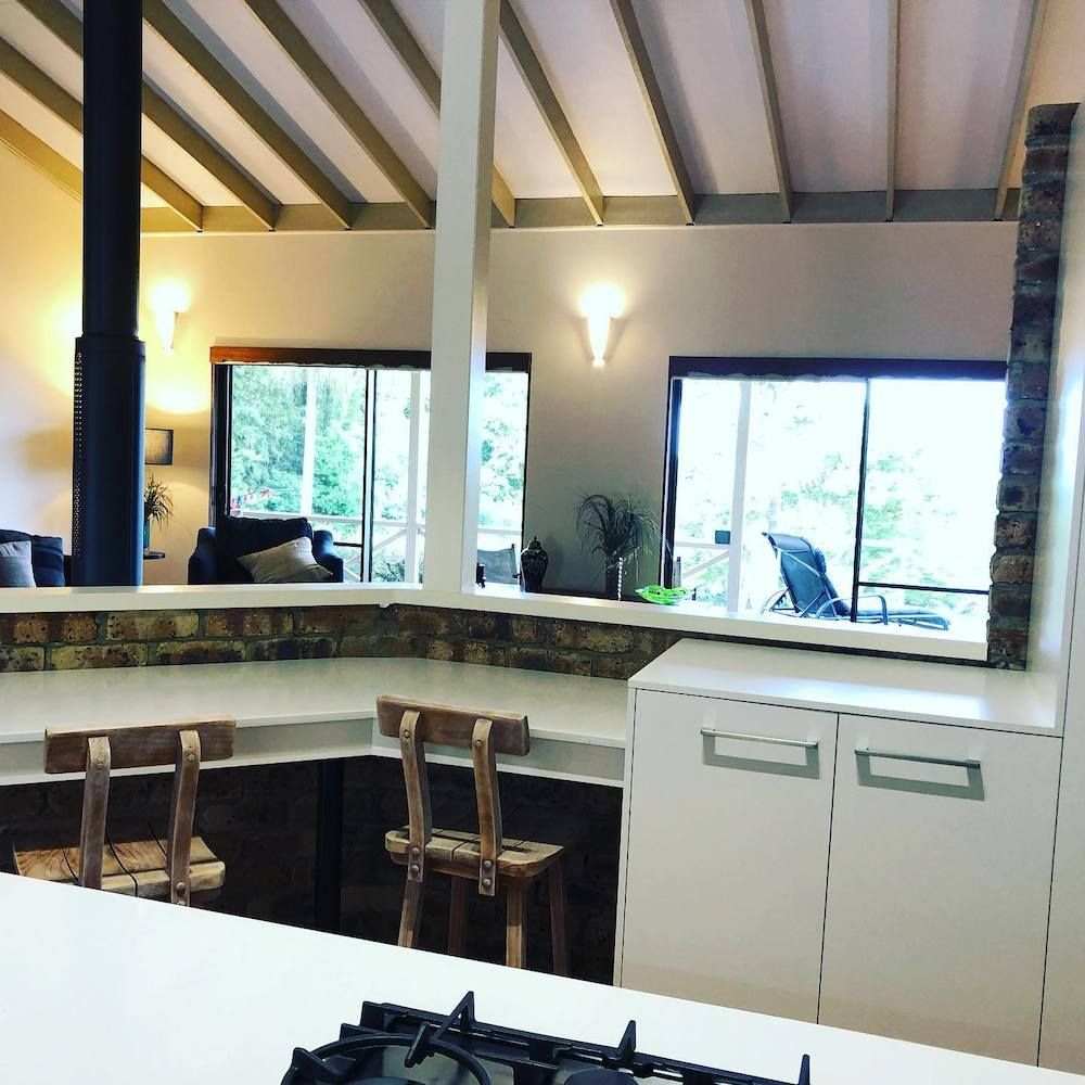 A Kitchen With A Stove Top Oven And Chairs — Alstonville Kitchens In Byron Bay, NSW