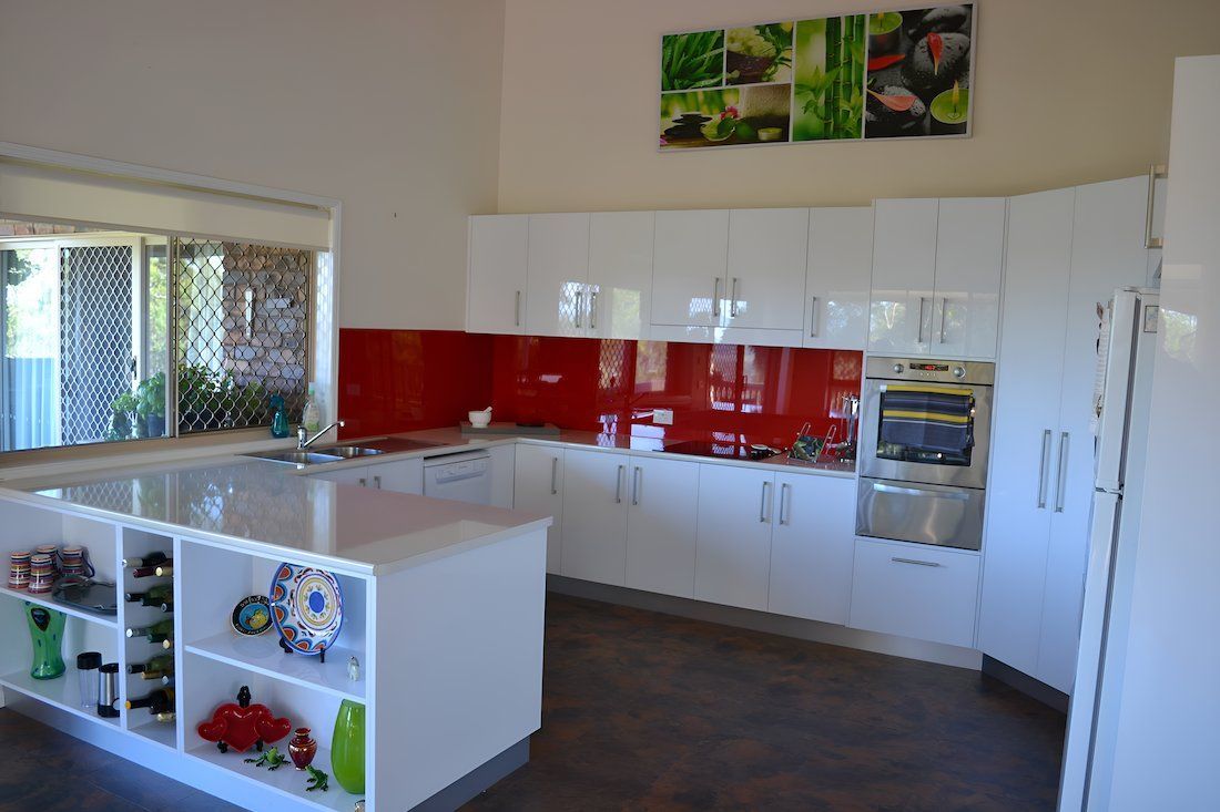 A Kitchen With White Cabinets And A Large Island In The Middle — Alstonville Kitchens In Alstonville, NSW