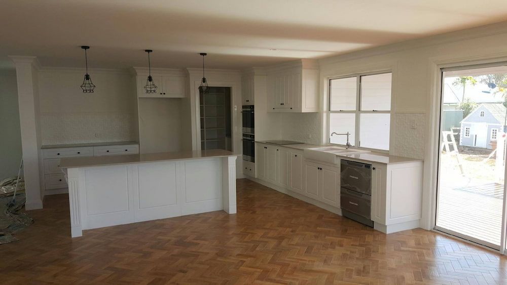 Spacious Bright Kitchen With White Cabinetry