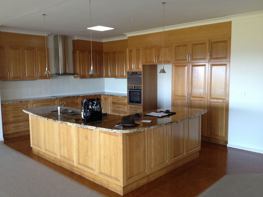 Spacious Kitchen With Light Wood Cabinets