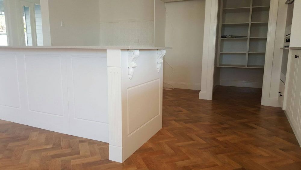 Spacious Kitchen With a White Island Countertop