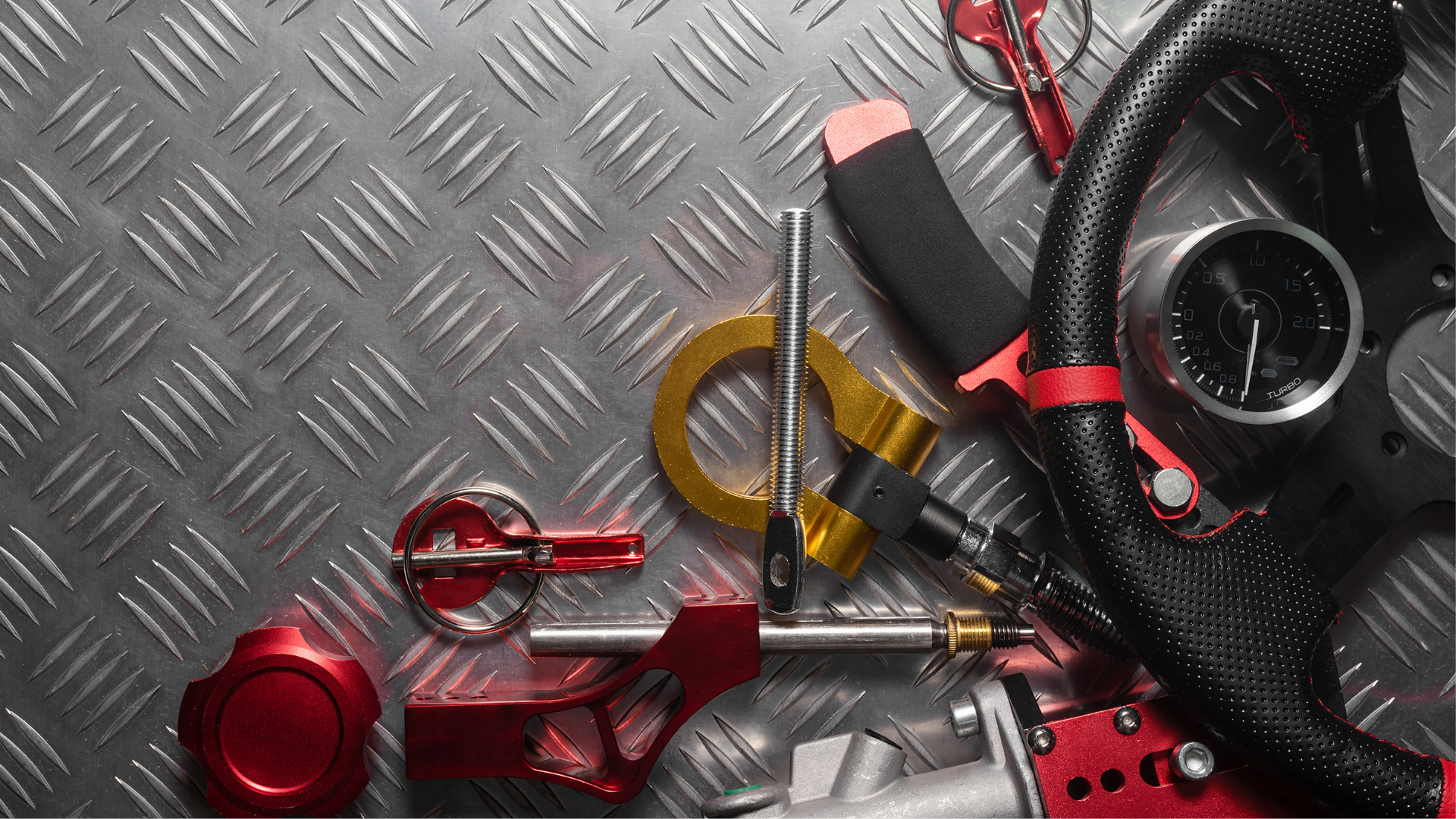 A bunch of car parts are laying on a metal surface.